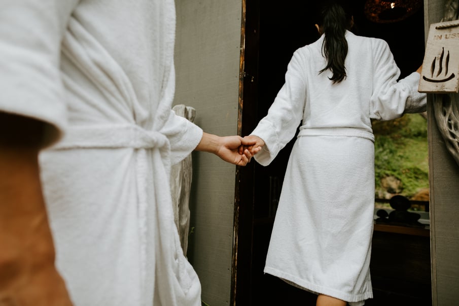Two people walking into a private bathing pavilion