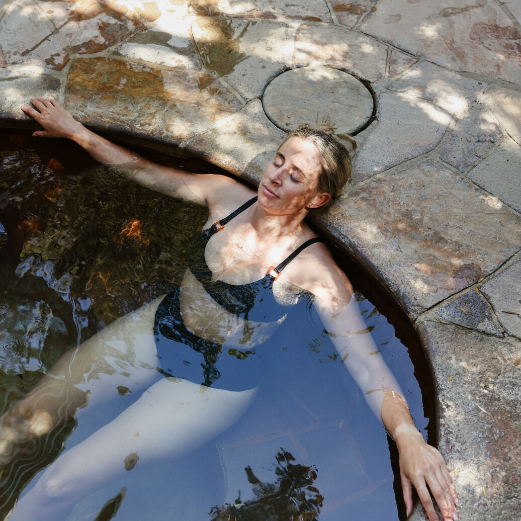 Woman bathing in hot springs water