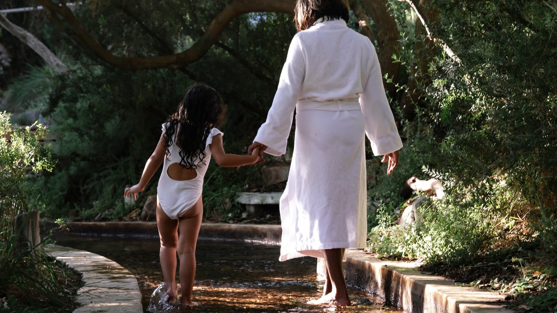 A mother and daughter walking along the Reflexology walk