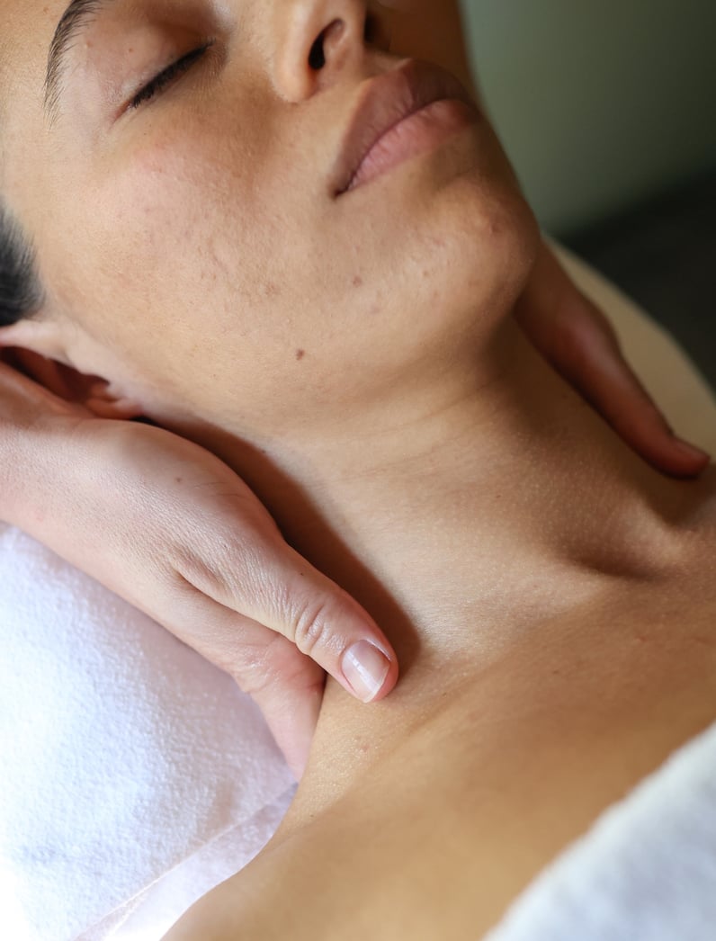 A person receiving a neck massage