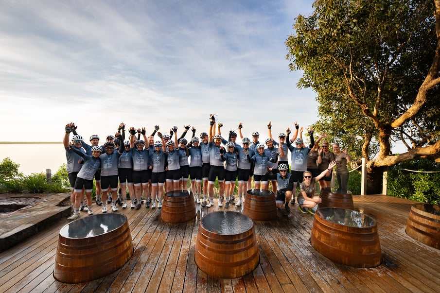A group of riders standing in the front of the bathing barrels at Metung Hot Springs