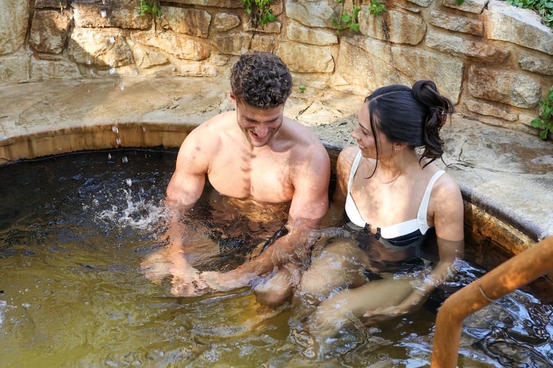 A man and woman bathing in a hot spring pool