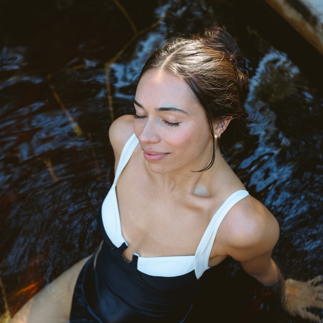 A woman in black bathers bathing in the Spa Dreaming Centre