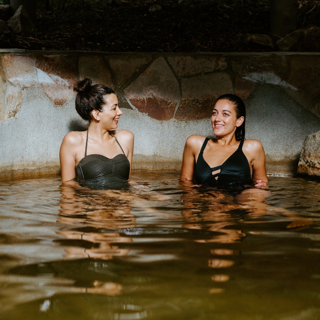 Two women bathing in hot springs