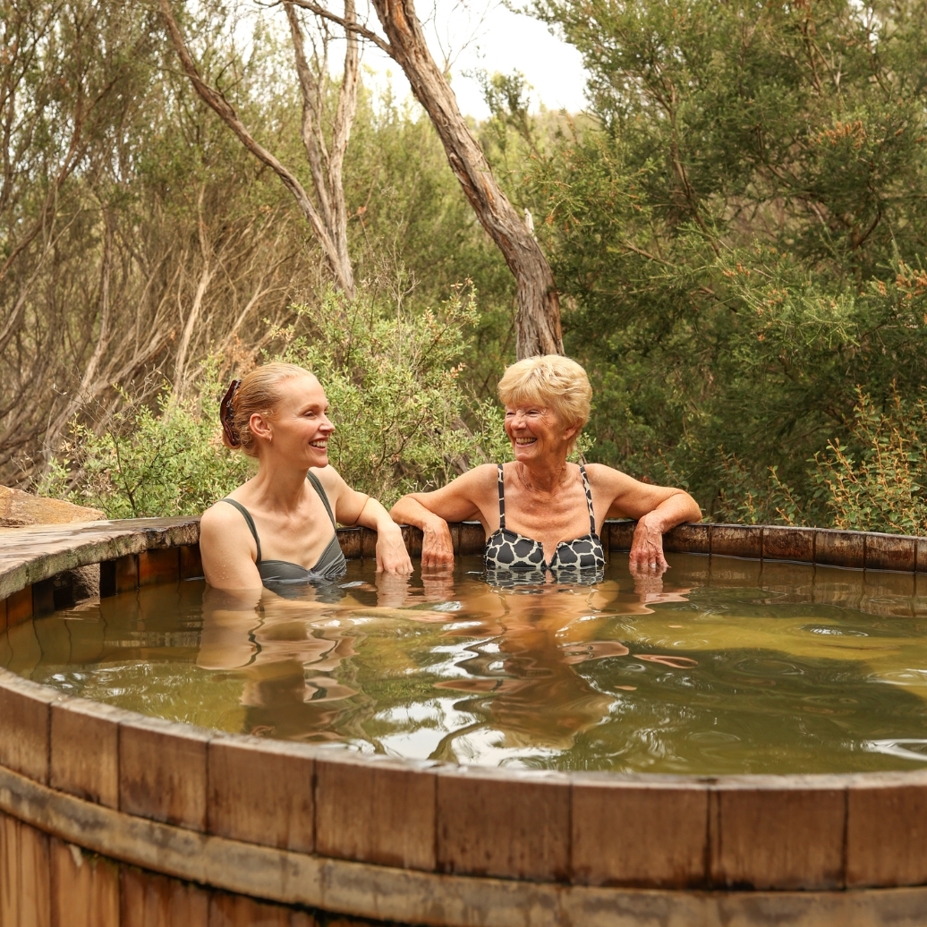 A mother and daughter bathing in the bathing barrel