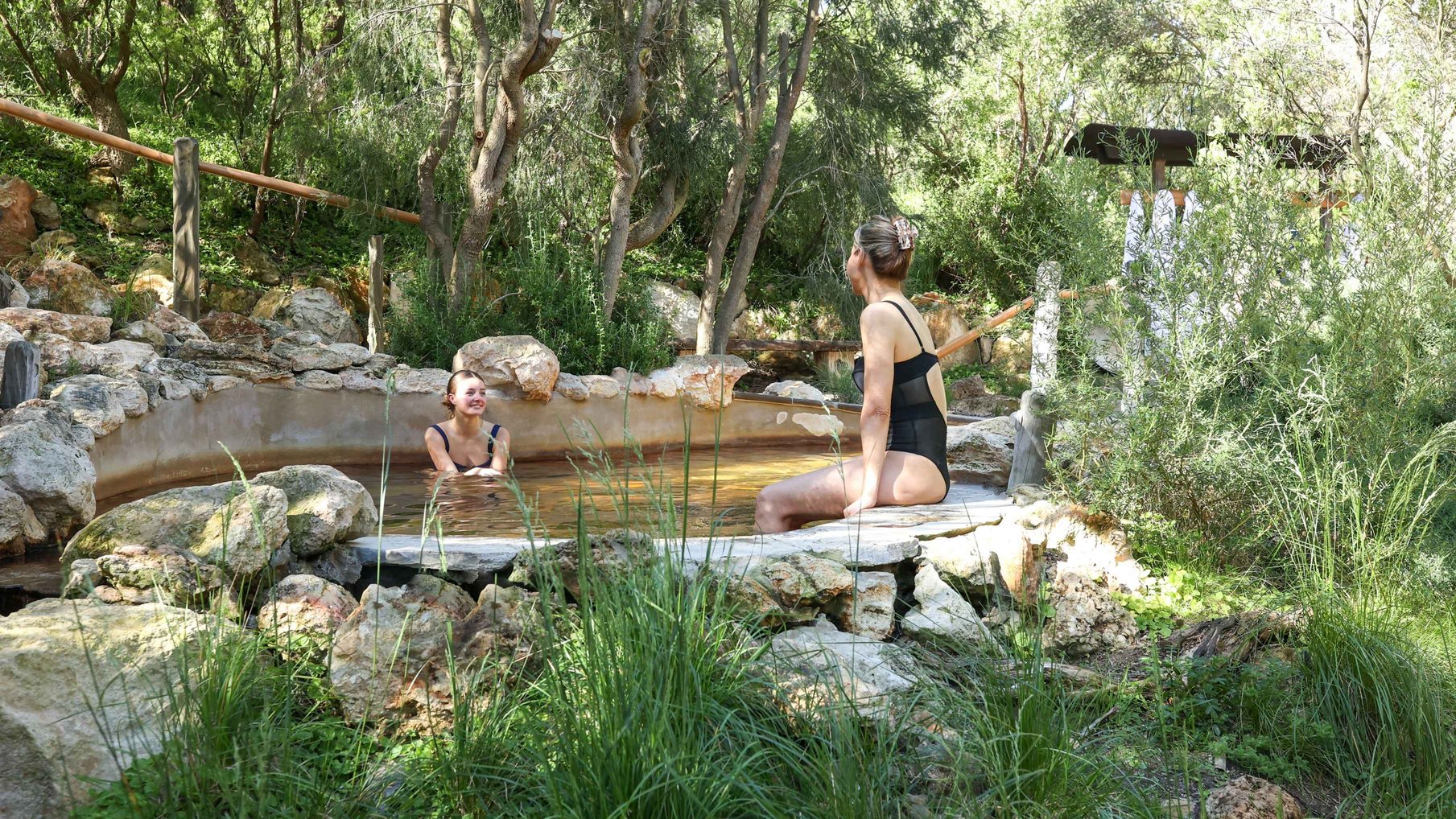 A mum and daughter bathing in hot springs