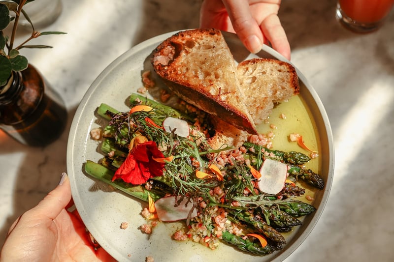 A plate of seasonal asparagus and crusty bread with garnishes
