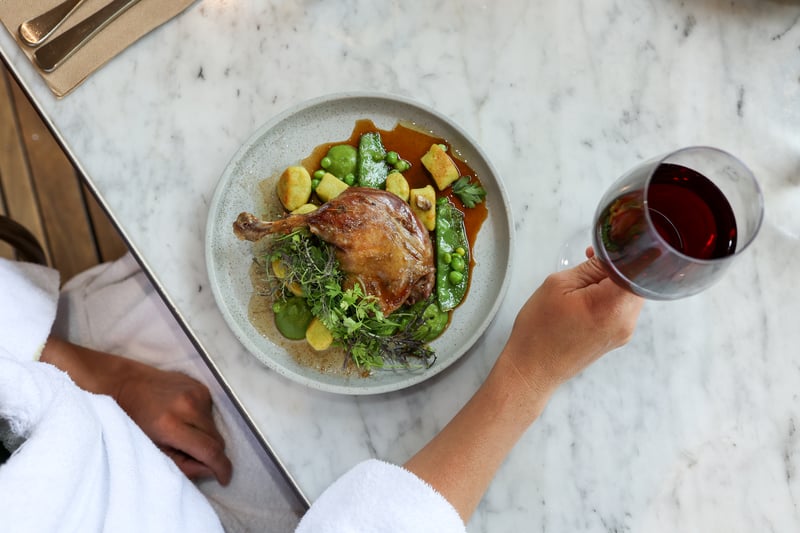 A plate of seasonal food and a glass of red wine