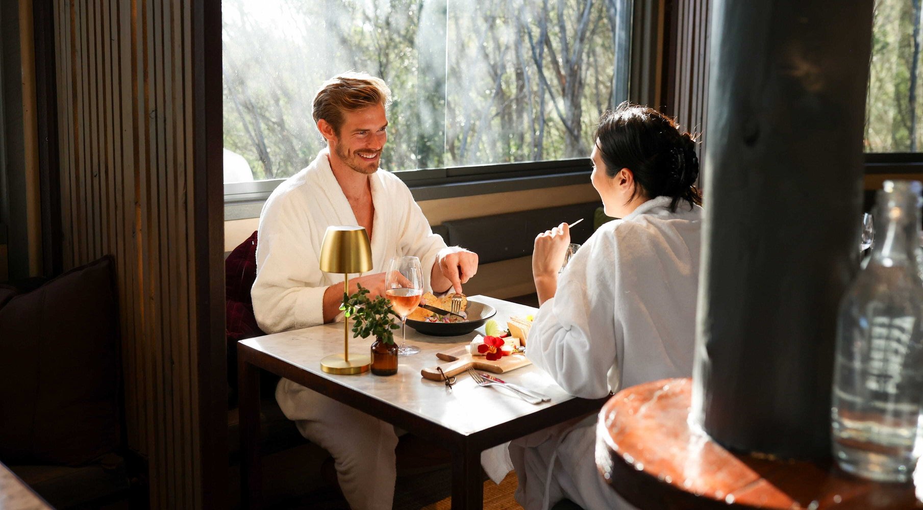 Two people dining in white robes