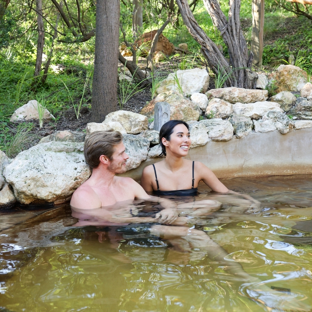 Two people bathing in hot springs