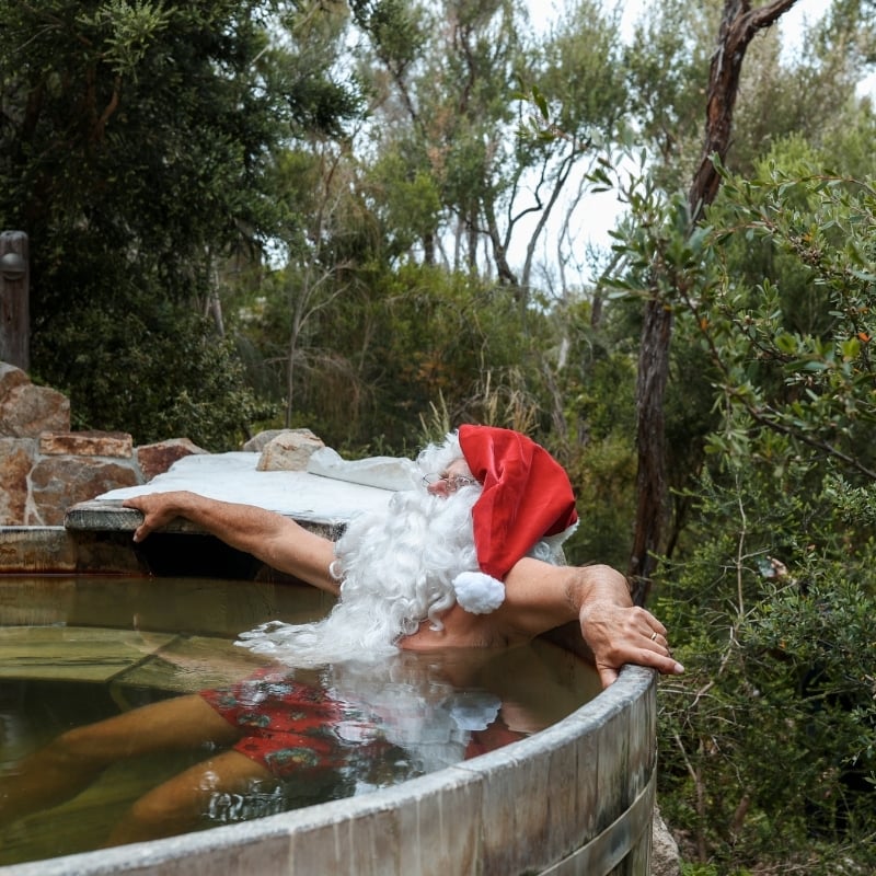 Santa bathing in hot springs
