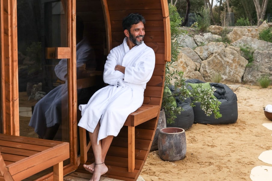 A person sitting in a Nordic-inspired sauna