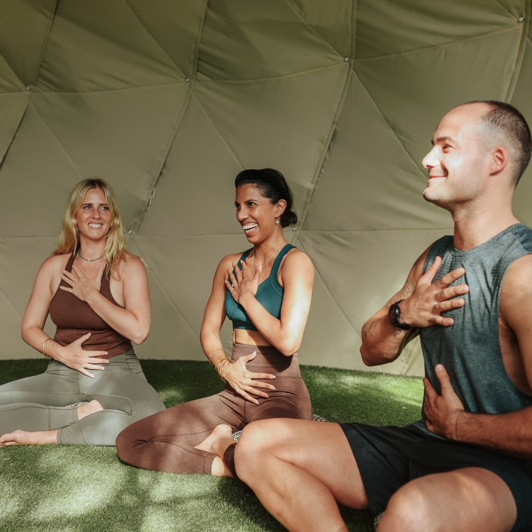 Three people meditating in the Sound Dome