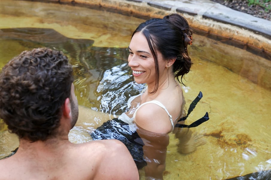 Two people bathing in hot springs