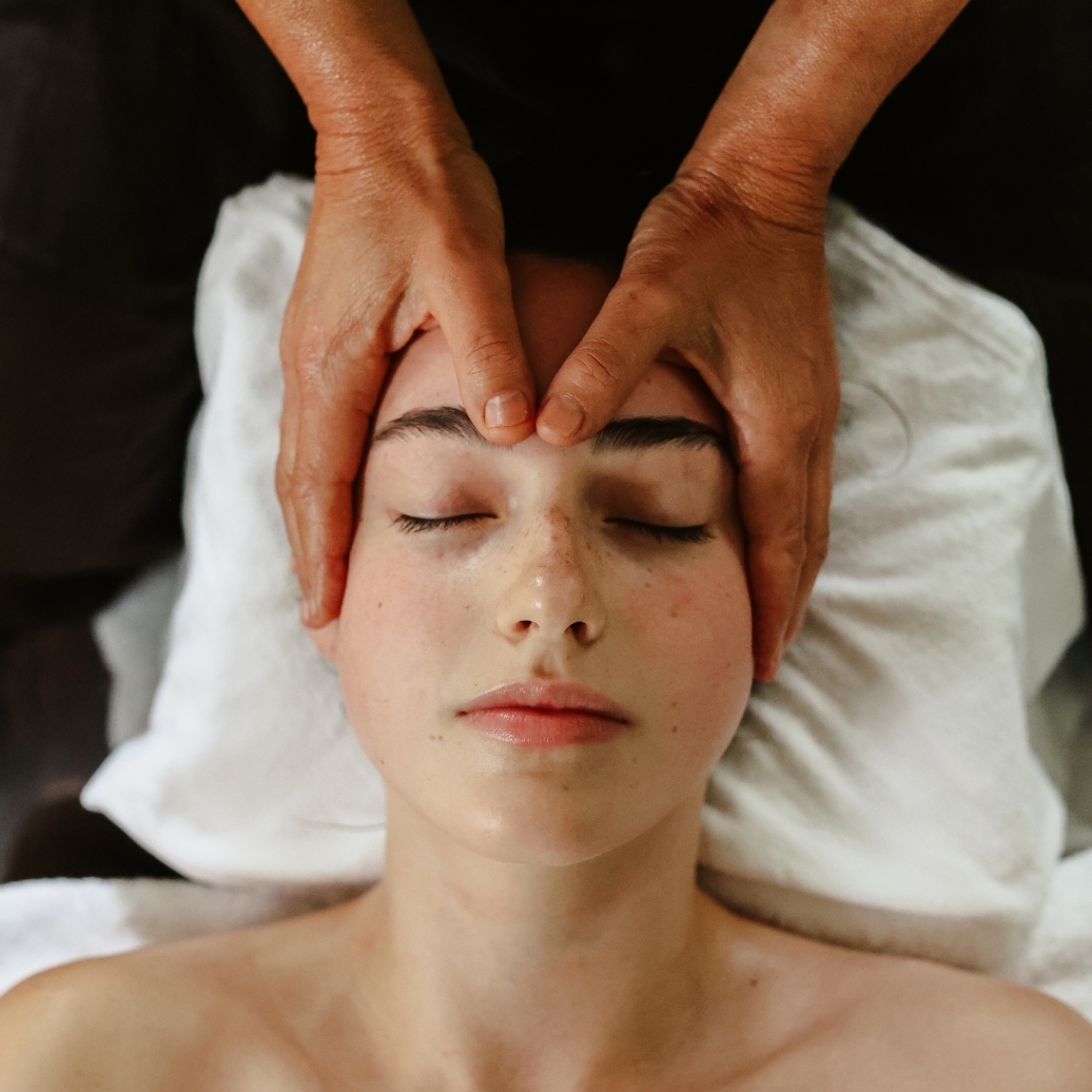 A young woman having a head massage