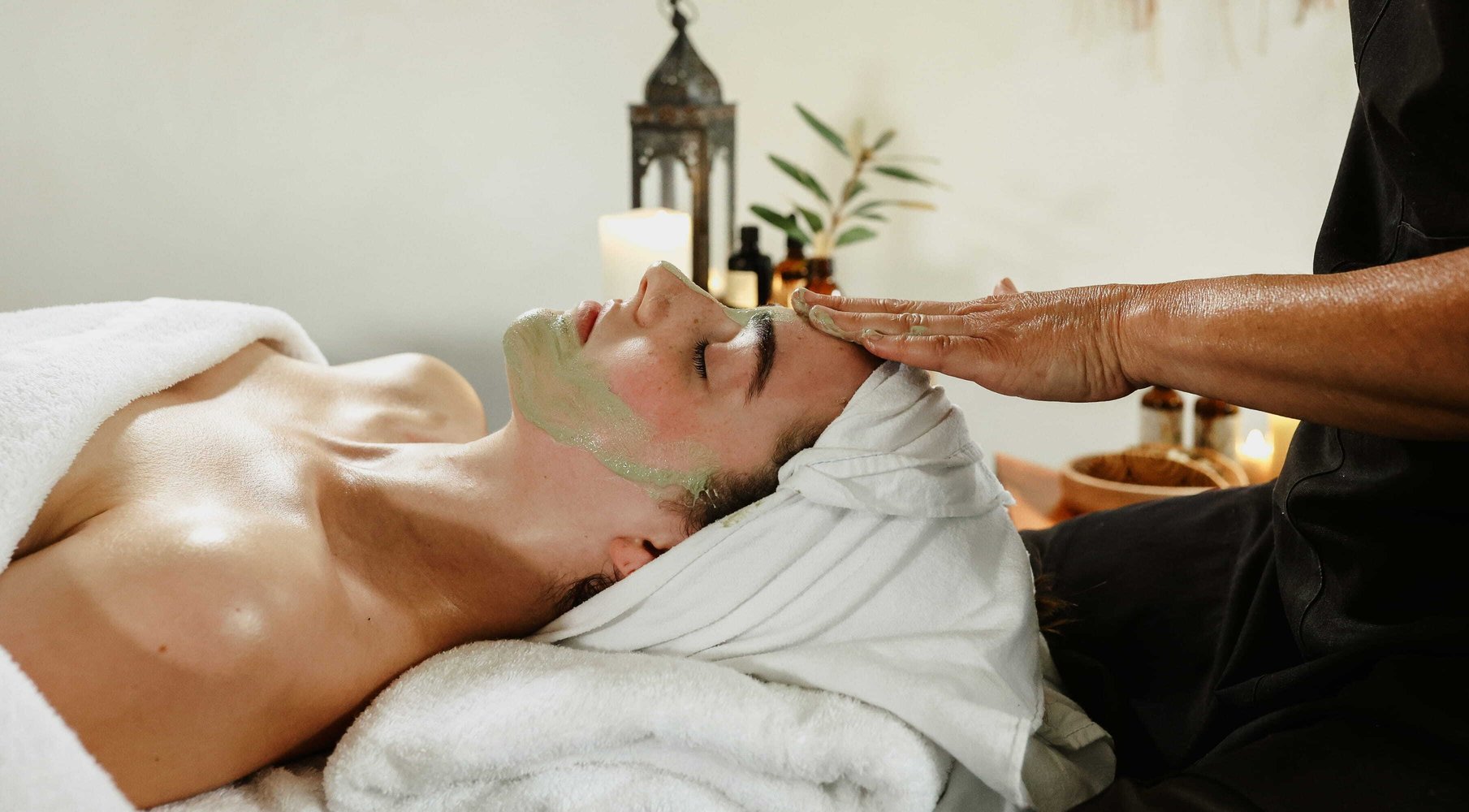 A young woman receiving a facial