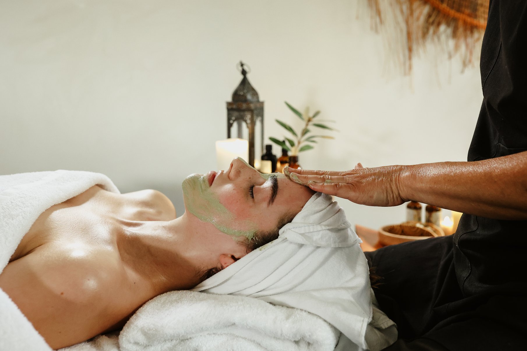 A young woman receiving a facial