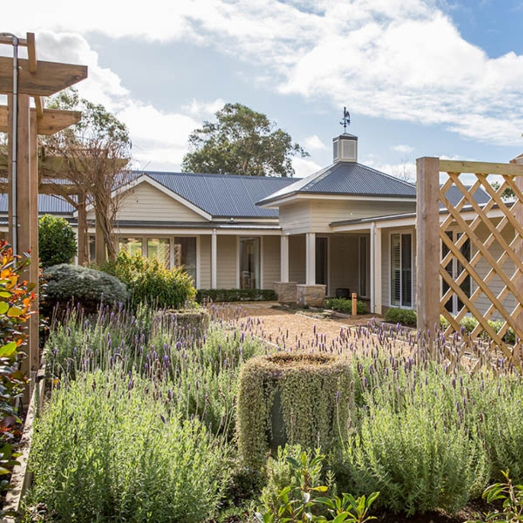 The exterior of a white farm style house