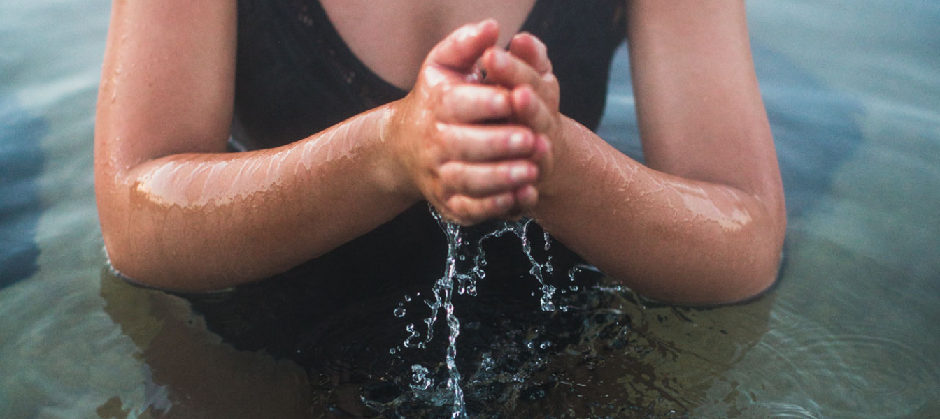 A person moving water through their hands
