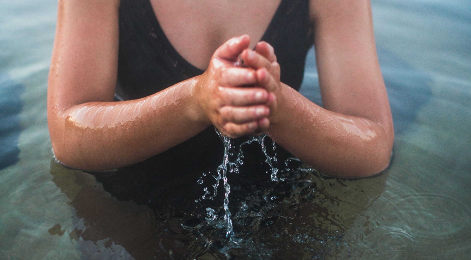 A person moving water through their hands