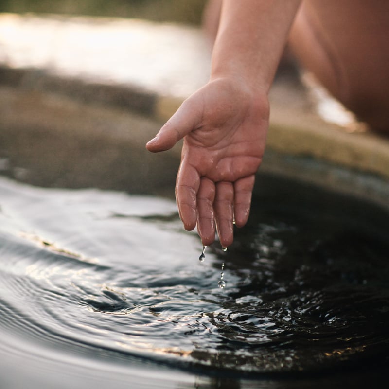 A person moving their hand through water