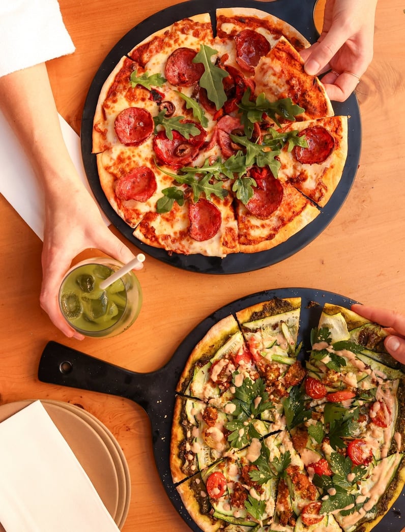 Two people having pizzas in the Amphitheatre Cafe