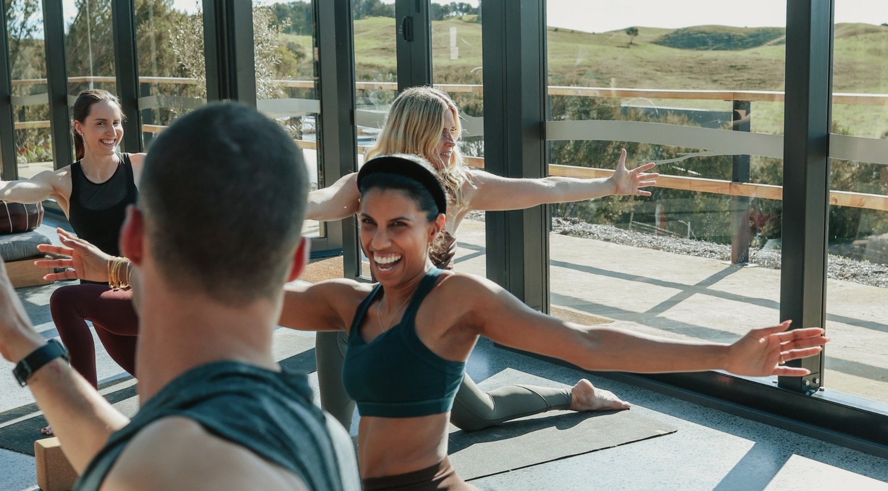 A group doing Yoga in the Glasshouse