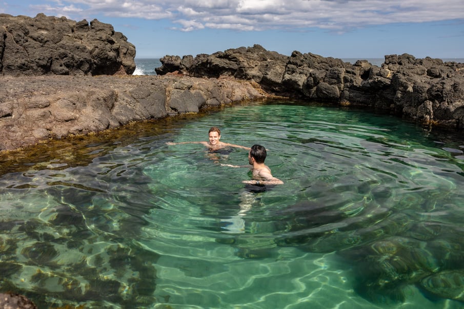 Two people swimming in the rock pools in Sorrento