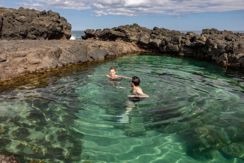 Two people swimming in the rock pools in Sorrento