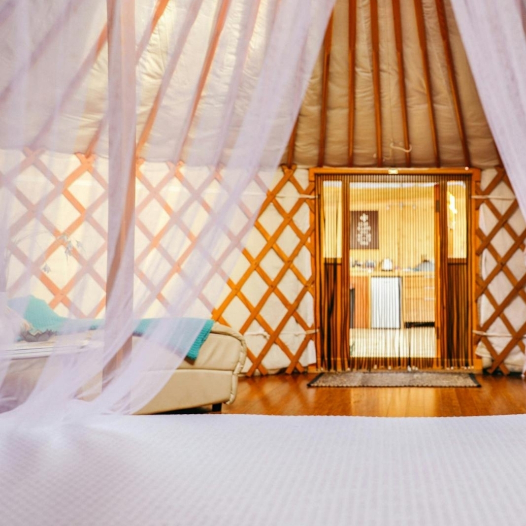 Curtains draping over a bed