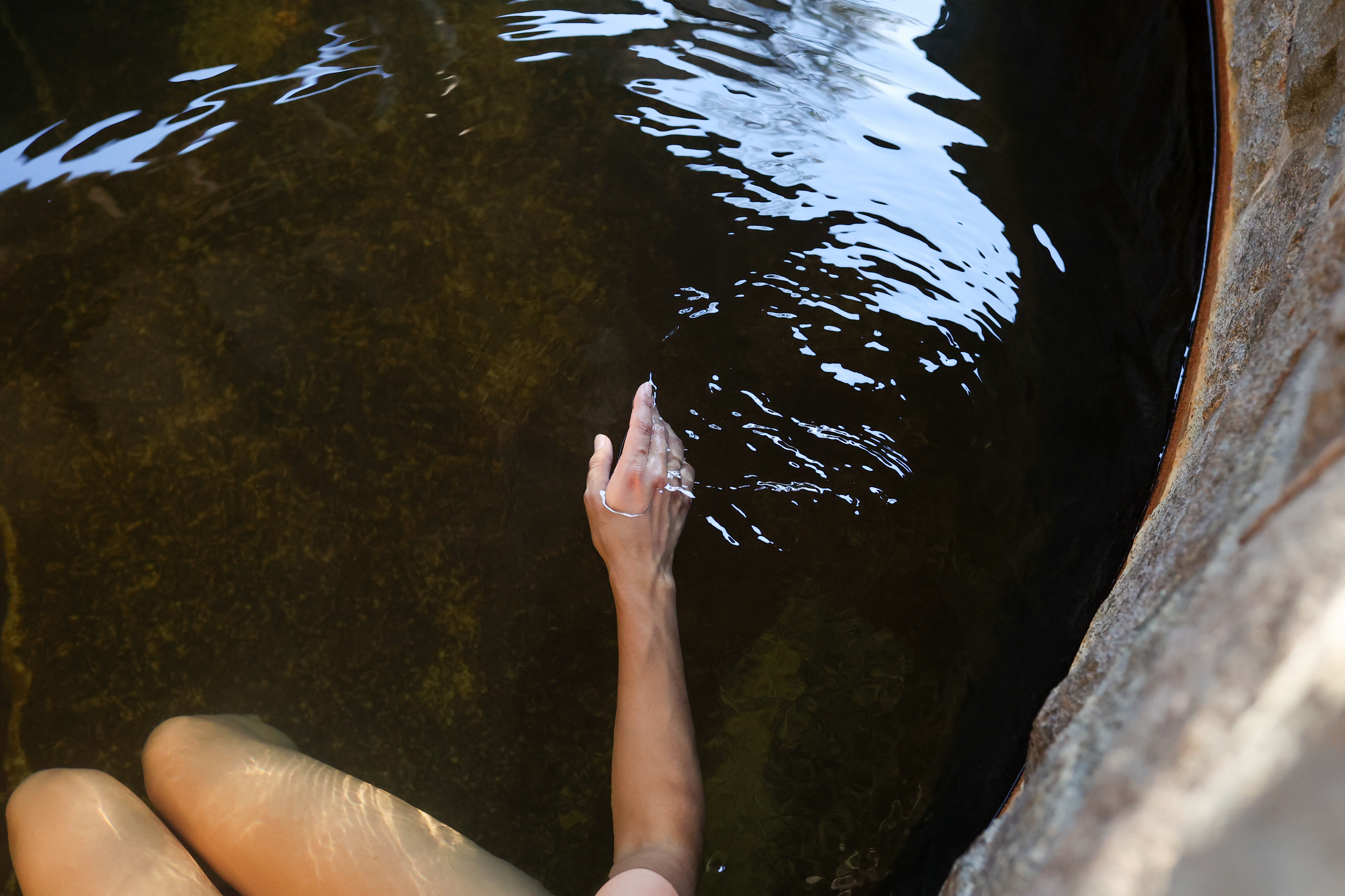 Woman sitting in hot geothermal water