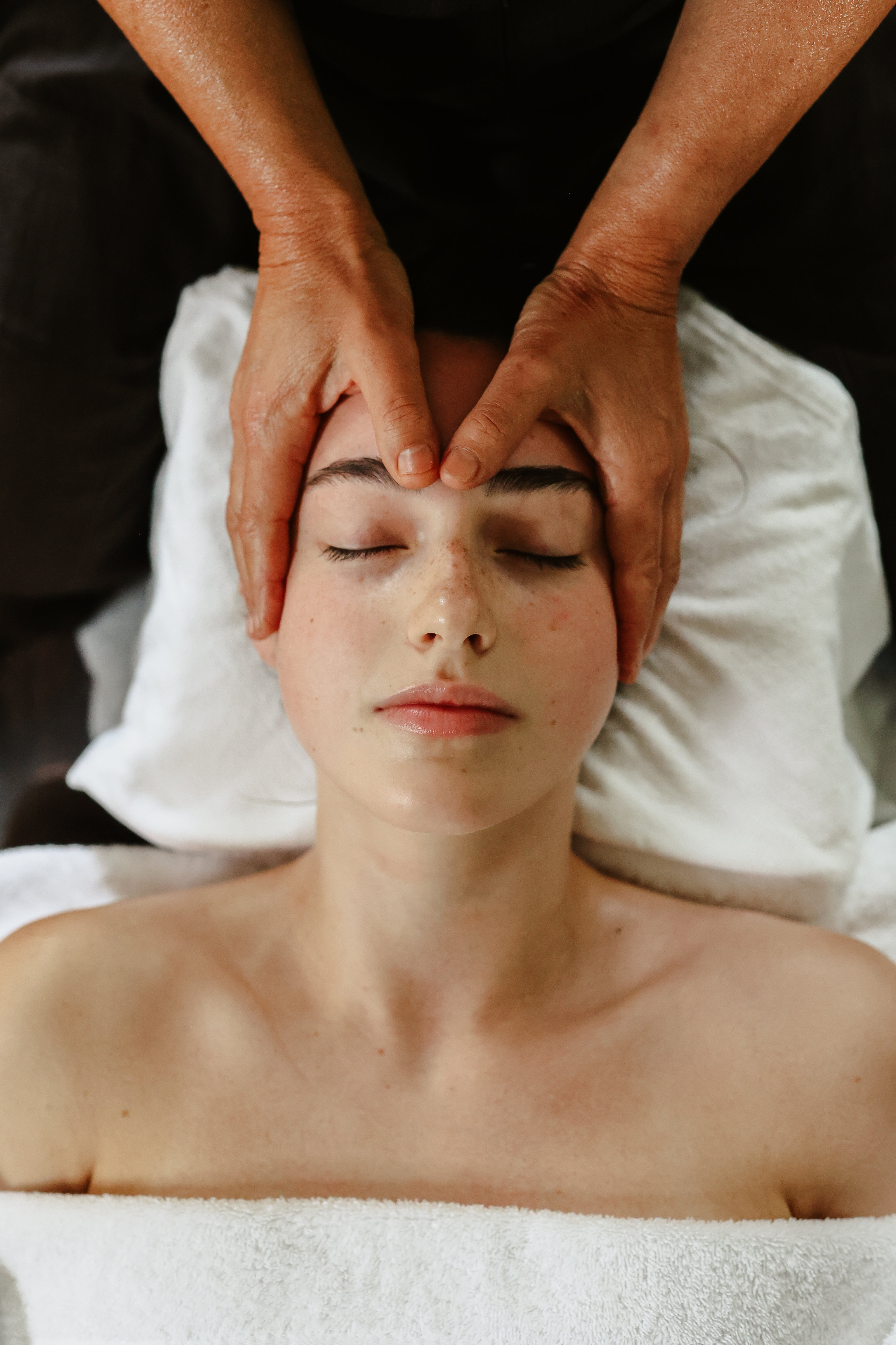 A young woman getting a facial