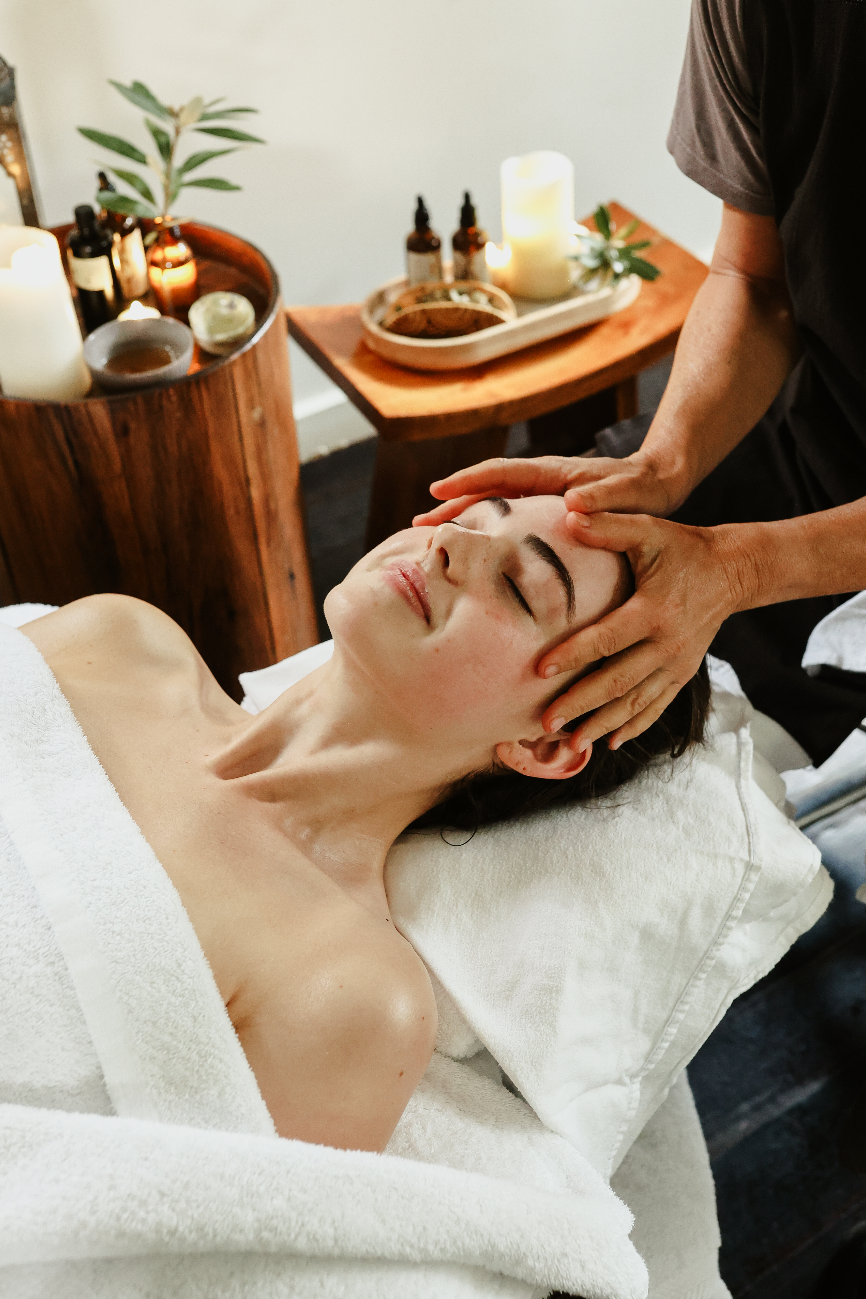A young woman receiving a head massage